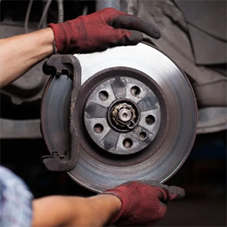 Man fixing brake disc